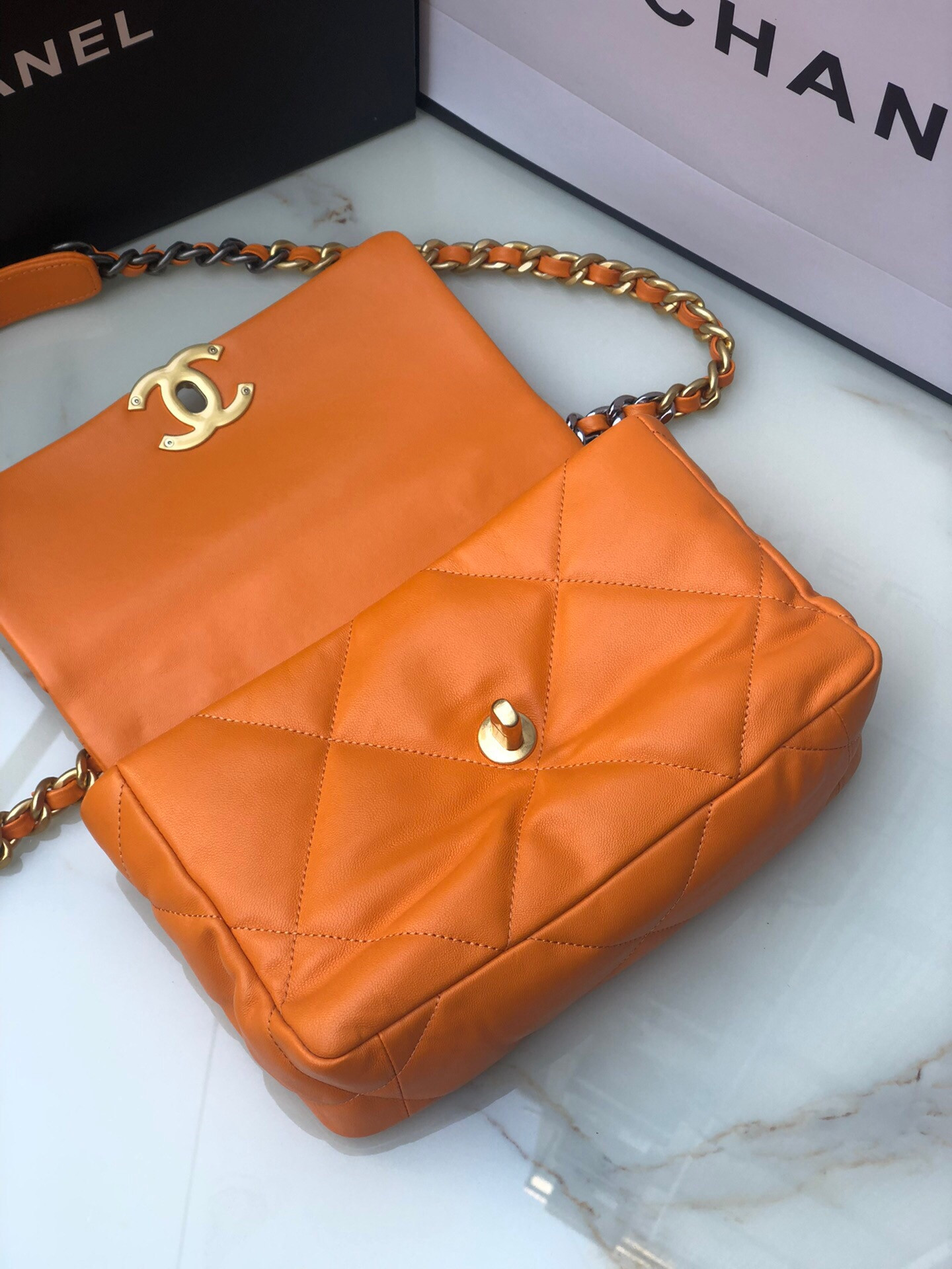 CHANEL 19 HANDBAG Shiny Leather, Gold-Tone, Silver-Tone & Ruthenium-Finish Metal Orange 6.2 × 10.1 × 3.5 in